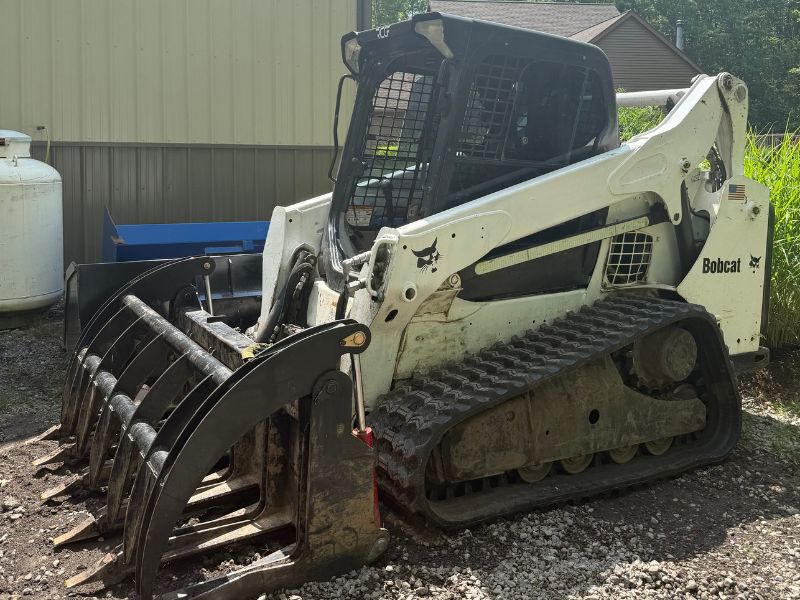 Bobcat T650 compact track loader equipped with 16-inch wide TrackTECH zig-zag tread replacement rubber tracks for OEM fit and stronger traction