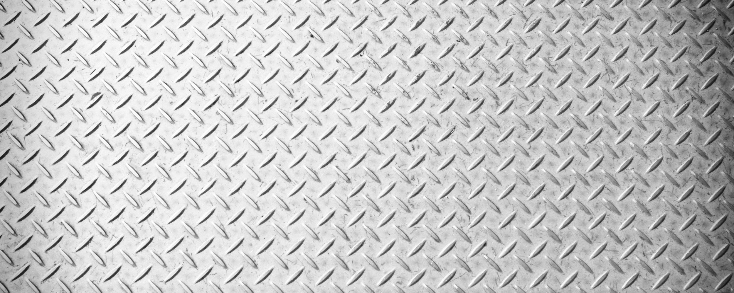 Diamond plate pattern on a metallic surface