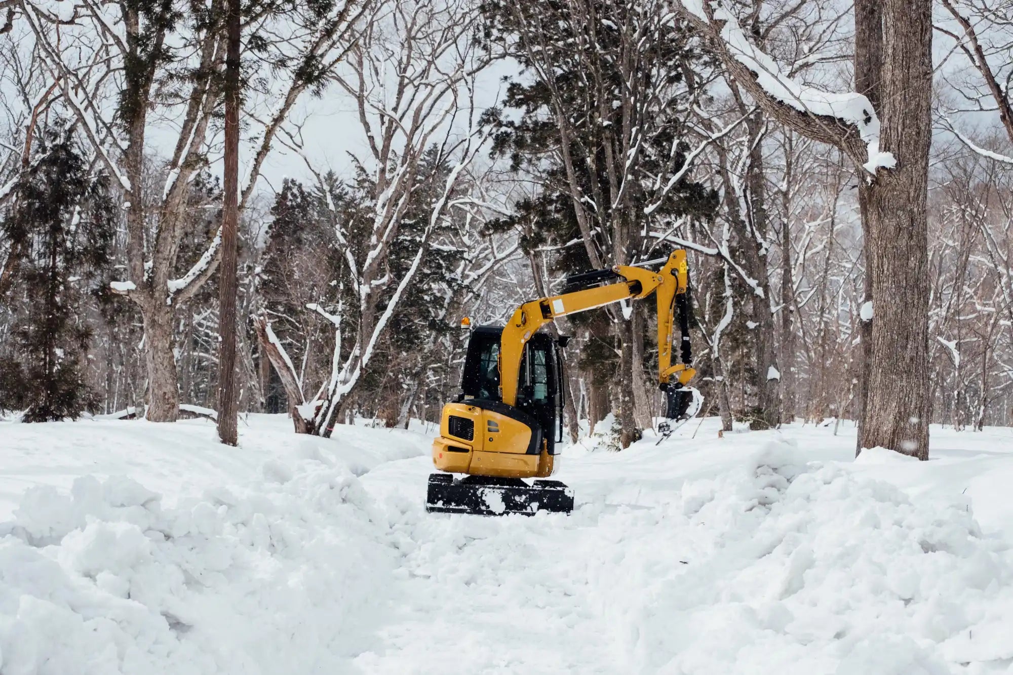 Mini Excavator conducting snow removal operations. 